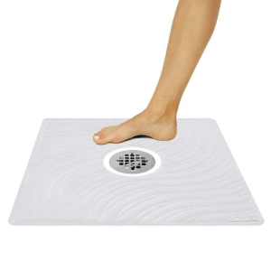 Non-slip shower mat with textured surface and suction cups, providing secure footing and added stability in the shower.